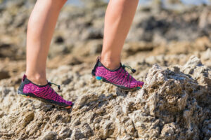 womed barefoot running shoes on a rocky trail